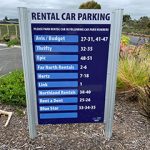 A signboard with the parking bays operated by Kerikeri rental car companies like Blue Star
