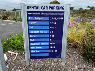 A signboard with the parking bays operated by Kerikeri rental car companies like Blue Star